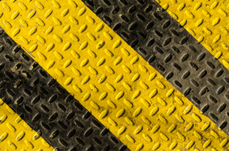 grunge black and yellow iron surface backgroundの写真素材
