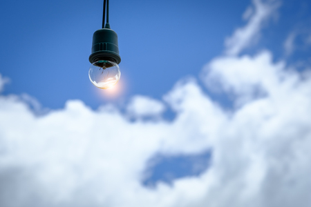 Lamp bulb on a sunny day and blue skyの写真素材