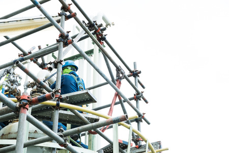 worker wear safety belt work at hight on scaffolding isolate white backgroundの写真素材