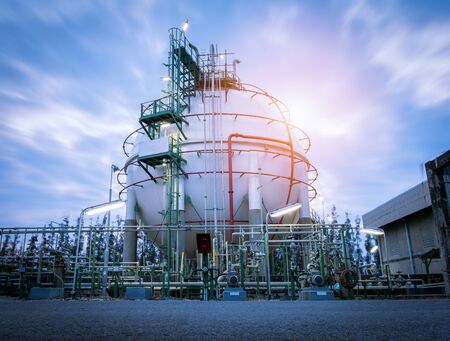 Gas storage spheres tank in oil refinery plant on sky sunrise backgroundの写真素材