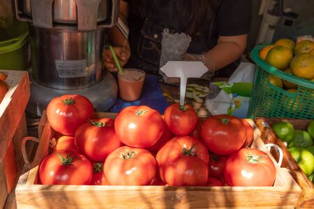 Red ripe tomatoes in basket prepare to do tomato juice for sale at market in Thailand.の写真素材