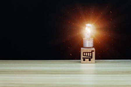 The idea of baked light bulbs on wooden blocks is the idea of a new way of shopping. Concept of shopping ideas on black backgroundの写真素材