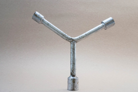 3 way lug wrench with brown backgroundの写真素材
