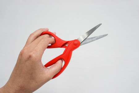 isolated close up women hold scissors for cutting with left handの写真素材