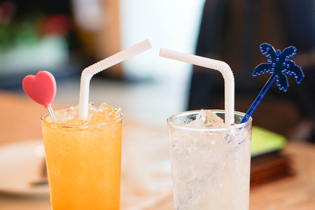 Decorative glass of orange juice and lemonadeの写真素材