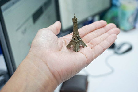 hold model Eiffel Tower in handの写真素材