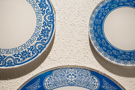 Porcelain white and blue chinaware on the white wallの写真素材