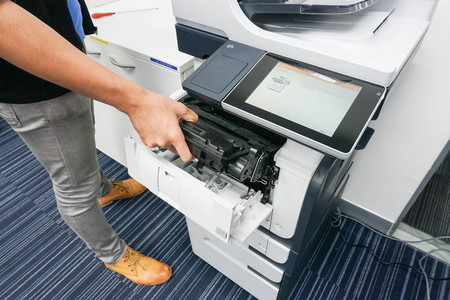 businessman put the ink cartridge into printerの写真素材