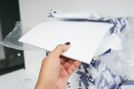 Pull paper from the ream to insert into printerの写真素材