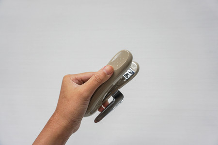 isolated woman hold stapler in left handの写真素材