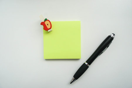 isolated mock up green sticky note with pen