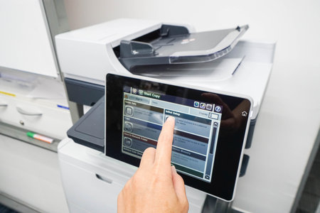 woman press printer screen for print set up with left handの写真素材