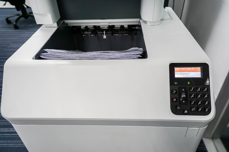 close up printer output tray with paper sheetの写真素材