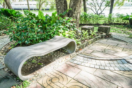 creative stone bench under the tree in the parkの写真素材