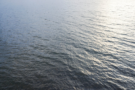 water waves in river in sunsetの写真素材