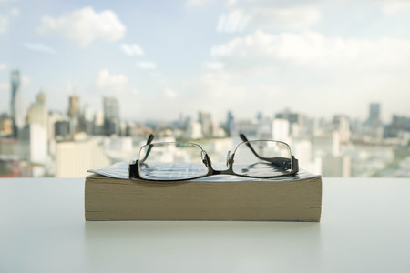 men glasses on the bookの写真素材