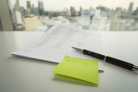 handwriting message note of meeting on green postitの写真素材