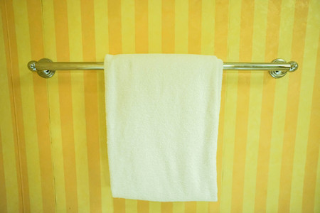 white towel on the metal rail inside bathroomの写真素材