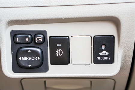 close up wing mirror personal car control panel