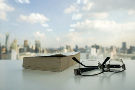 men glasses beside the book for reading