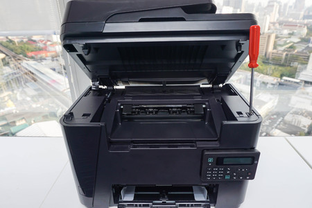 office printer is repaired with red screwdriverの写真素材