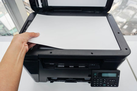 woman place paper sheet on printer glass plate for scanning