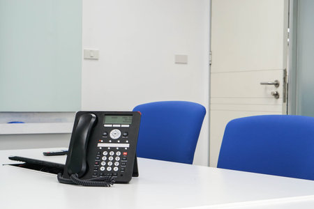 Close up IP phone in modern boardroom for meeting