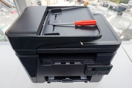 place red screwdriver on the printer plate for repairの写真素材