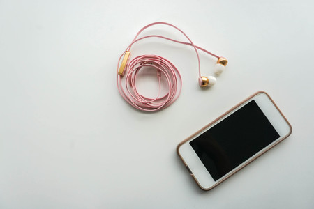 isolated smartphone with pink earphoneの写真素材