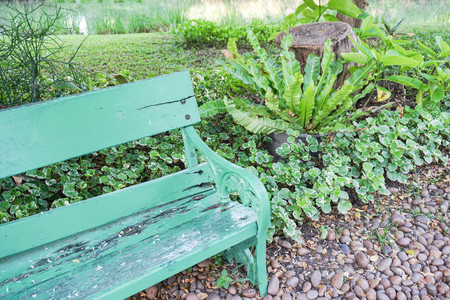 part of green wooden bench in the pleasant parkの写真素材