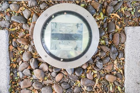 close up creative design light bulb on the ground at garden nearby hotel swimming poolの写真素材