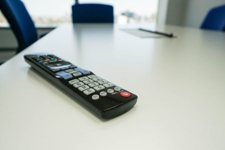 TV remote control in meeting room table with selective focusの写真素材
