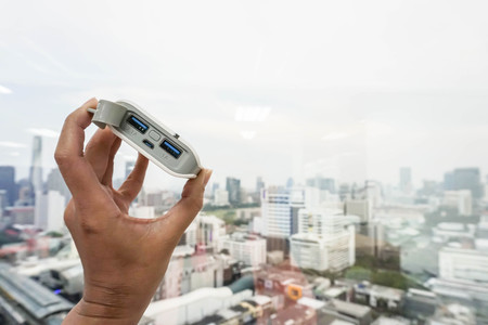 close up woman hold power bank supply energy to mobile phone with left handの写真素材