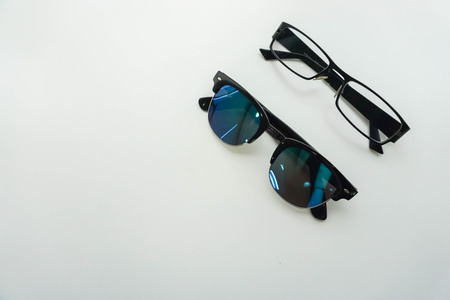 isolated sunglasses and modern men glasses on office deskの写真素材