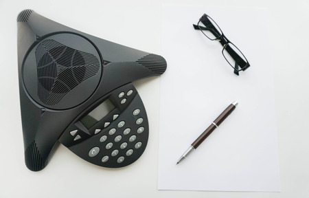isolated top view of Voip IP conference phone with glasses and penの写真素材