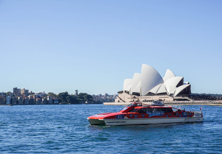 red cruise with tourists on the ocean taken at Opera House in Sydney Australia on 8 July 2016のeditorial素材