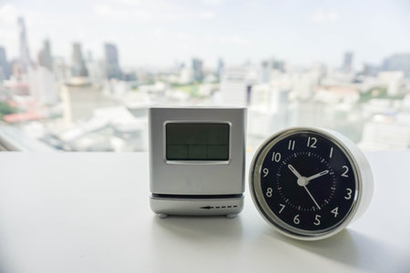 analog and digital modern clock on white table