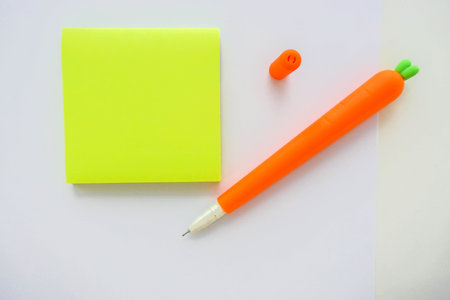 isolated mock up postit on office desk with cute carrot pen for noting as reminder
