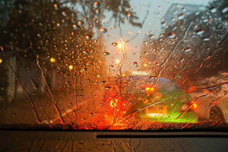 raindrops and street light bokeh on wind shieldの写真素材