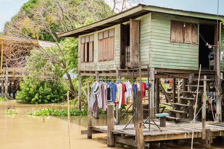 green old vintage wooden house at riversideの写真素材