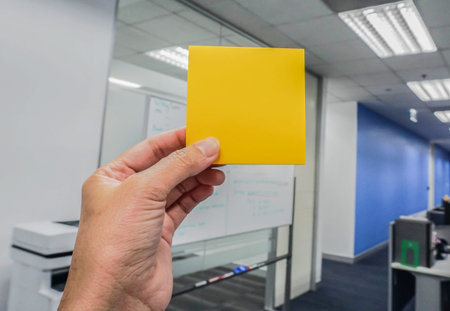 businesswomen hold mock up orange posit with left hand in office