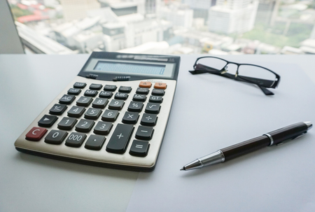 Calculation with eyeglasses and pen for salary and bonus calculationの写真素材
