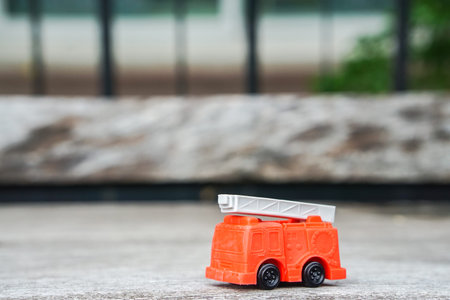 red electricity and utility service truck model toy on wooden floor for kid