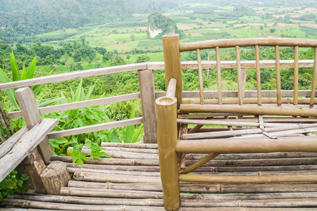 close up bamboo bench at hill top for mountain viewの写真素材