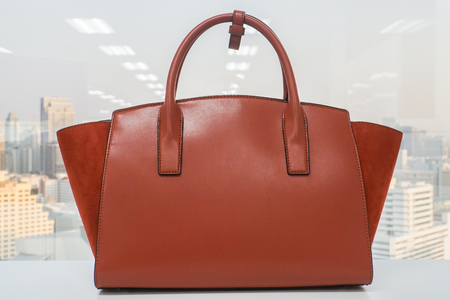 close up orange fashionable women leather handbagの写真素材