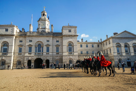 London / UK - November 17 2017: red cavalryman troop on strong black horse at The Household Cavalry Museumのeditorial素材