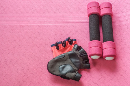 pink women workout set - dumbbell and yoga mat with fitness glovesの写真素材
