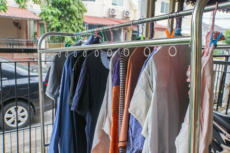 close up dry women and men cloths at indoor hangerの写真素材