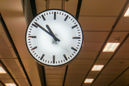 big hanging analog clock at underground train stationの写真素材