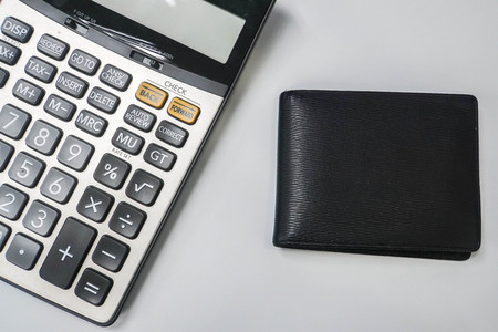 finance concept - isolated men leather wallet with calculatorの写真素材